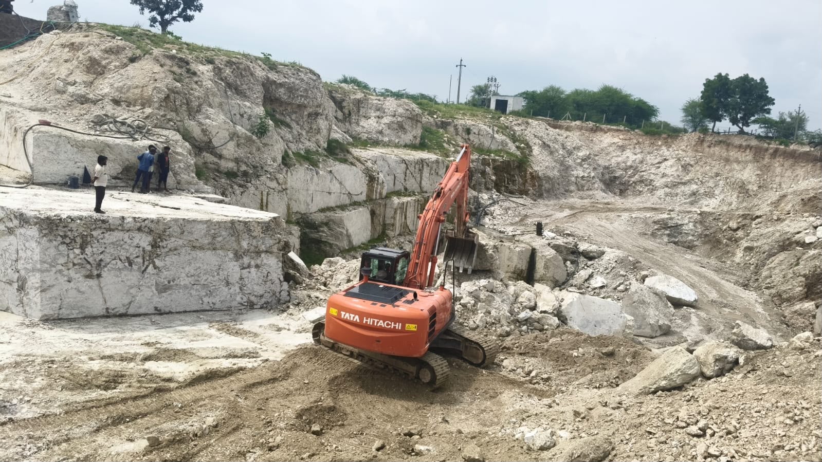 Manit Minerals quarry in India with excavator working white mineral benches